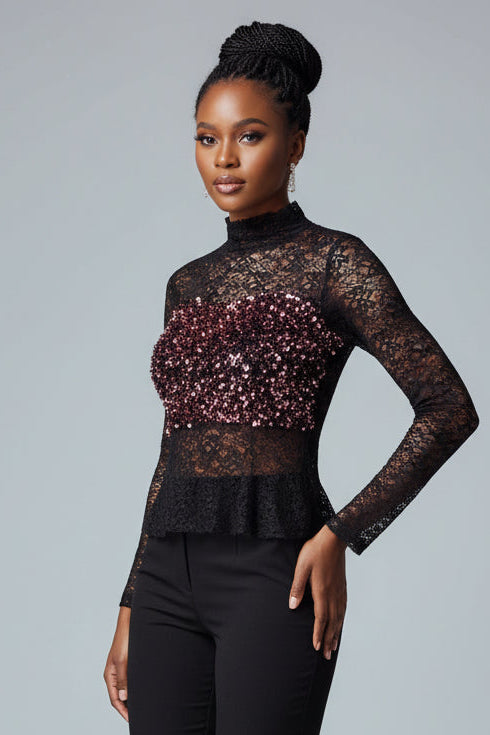 Black lace top worn by a person against a neutral background
